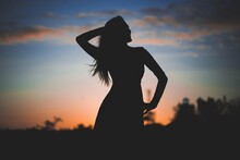 Silhouette Of A Woman In The Sunset