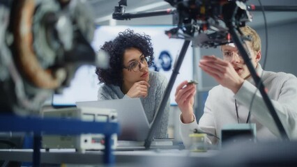 Poster - Diverse Engineers Discussing Microchip and Put it Into the Drone. Startup and Innovative Technologies in Unmanned Aerial Vehicle Concept. Portrait View