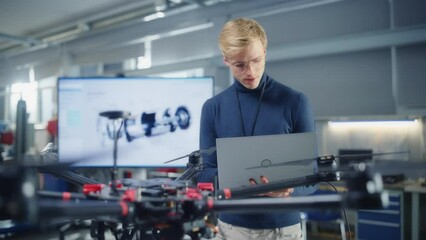 Aufkleber - Young Male Developer Programming at Laptop while Work on a New Drone Design at Research Center Laboratory. People Creating Unmanned Aerial Vehicle Concept. Portrait View