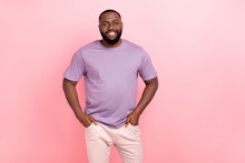 Portrait Of Attractive Cheerful Masculine Guy Holding Hands In Pockets Isolated Over Pink Pastel Color Background