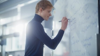 Wall Mural - Education, Learning, Mathematics Concept: Young Male Specialist Write Formulas and Solving Problems Behind the Whiteboard in Bright Modern Laboratory