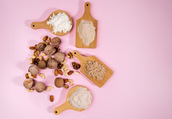 Alternative nut flour. Various keto paleo gluten, grain free. Almond, walnut, cashew flour. Copy space. Pink background