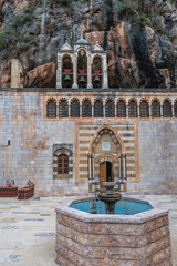 Sticker - Fountain and church in St Anthony Monastery also known as Qozhaya Monastery in Kadisha Valley, Lebanon