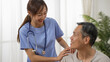 © PR Image Factory - Closeup of caring Asian woman nursing aide talking and encouraging older male patient during home visit. Domiciliary care for elderly senior concept