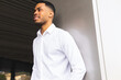 © ADDICTIVE STOCK - Serious black businessman near office building