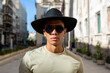 © ADDICTIVE STOCK - Serious Hispanic man in hat