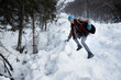 Dangerous Hiking downhill on frozen snow avalanche wearing crampons in Julian Alps, Slovenia