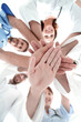 © ASDF - bottom view.a team of doctors at the medical center clasped their hands together