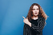 © JJ Studio - Portrait of astonished girl promoter impressed incredible adverts promo look, point index finger touch hand face wear casual style clothes isolated background