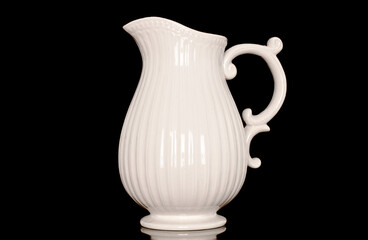 Canvas Print - One ceramic milk jug, close-up, isolated on a black background.