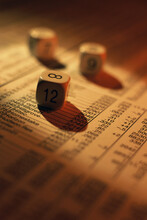 Three Numbered Dice On A Financial Report