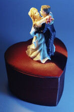 High Angle View Of A Bride And Groom Figurine On A Box