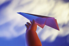 Close-up Of A Doll's Hand Holding A Paper Plane