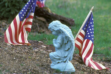 Close-up Of A Statue And An American Flag