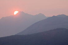 USA, Washington State, Seabeck, View Across Hood Canal To The Olympic Mountains At Sunset With Forest Fire Smoke In Air