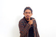 © ArvStd - Asian man over isolated white background unhappy and pointing to the side