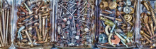 Close-up Of Nuts And Bolts With Screws And Nails In Jars