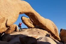 USA, California, Joshua Tree National Park, Woman Under Arch Rock
