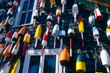 USA, Maine, Colorful Lobster Buoys Hanging On Wall Of House