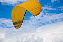 Yellow Parachute Against Blue Sky
