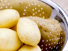 Close Up Of Washed Potatoes In Metal Colander