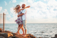 Honeymoon. A Young Couple Of Beautiful Woman And Man Are Standing And Hugging On The Seashore. Copy Space. Just Marriage
