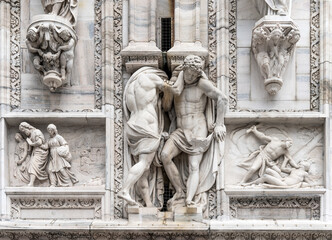 Poster - Marble sculpture depicting strong muscled telamons and other bas reliefs, detail on the façade of the Milan Cathedral, Lombardy region, Italy