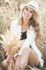 Wall Mural - Young attractive woman in the hat. Closeup portrait of beautiful woman outdoors. Pretty lady smiling