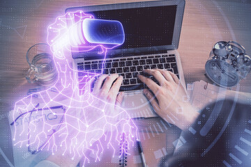 Double exposure of man's hands typing over computer keyboard and virtual reality hologram drawing. Top view. Technology concept. Future.