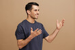 © SHOTPRIME STUDIO - man hand gesture gray t-shirt fun lifestyle beige background