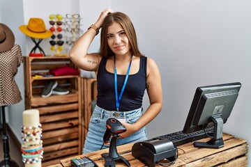 Sticker - Young brunette woman holding banner with open text at retail shop confuse and wondering about question. uncertain with doubt, thinking with hand on head. pensive concept.