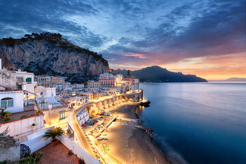 The village of Atrani, right next to Amalfi during sunrise with a beautiful sky and lights in the city. 