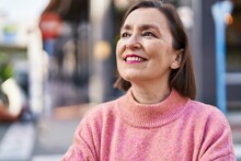 Middle Age Woman Smiling Confident Looking To The Sky At Street