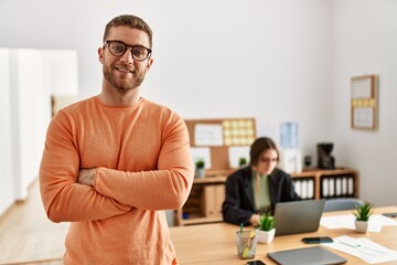 Wall Mural - Businessman smiling happy with arms crossed gesture standing at the office.