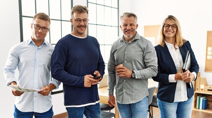 Wall Mural - Group of middle age business workers smiling happy standing at the office.