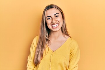 Wall Mural - Beautiful hispanic woman wearing casual yellow sweater with a happy and cool smile on face. lucky person.