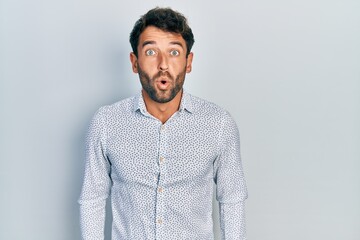 Sticker - Handsome man with beard wearing casual elegant shirt scared and amazed with open mouth for surprise, disbelief face