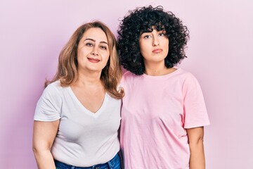 Sticker - Middle east mother and daughter wearing casual clothes relaxed with serious expression on face. simple and natural looking at the camera.