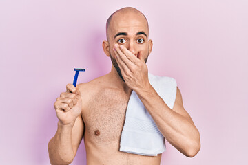 Sticker - Young bald man shirtless holding razor covering mouth with hand, shocked and afraid for mistake. surprised expression