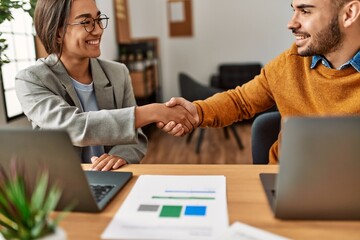 Canvas Print - Two business workers shaking hands at the office.