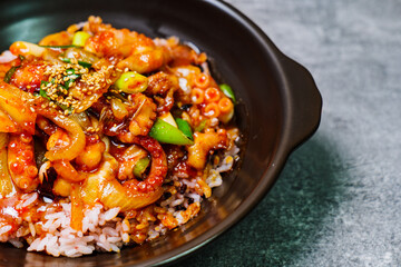 Wall Mural - Nakjideopbap, Korean style spicy stir-fried octopus over rice : This dish is made by stir-frying sliced onion and carrots along with sauce over high heat in an oiled pan. Bite-sized pieces of octopus 