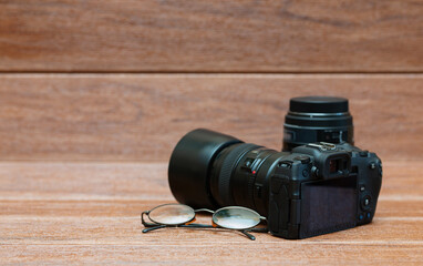 digital camera and lens on wooden floor