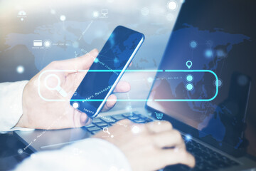 Poster - Close up of hand using laptop and smartphone with creative search bar and digital blue map icons on blurry background. Address and Url concept. Double exposure.