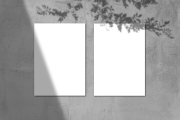 Empty white horizontal rectangular poster mockup with light shadow on gray concrete wall background.