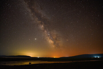 A breathtaking view of the Milky Way at night in Arpi lake, Armenia