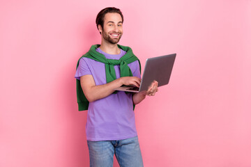 Wall Mural - Photo of happy good mood freelancer it specialist working in wireless netbook isolated on pink color background