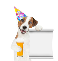 Poster - Happy Jack russell terrier puppy wearing a party hat holds  beer and empty list. isolated on white background