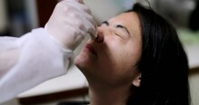 Person doing nose covid test painful procedure