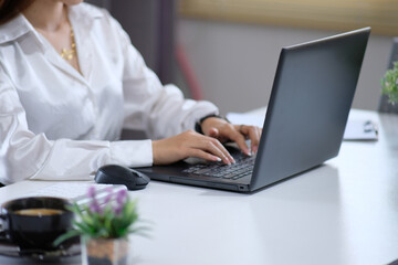 Poster - Closeup of a woman's hands typing on a computer keyboard, a businesswoman or a student at home using a laptop, online learning, internet marketing, working from home, office workspace, freelancing
