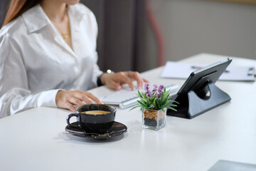Poster - Close-up of a female specialist's hands working on a laptop computer while sitting at a table in a office. Freelancer Woman Interacting on Social Media